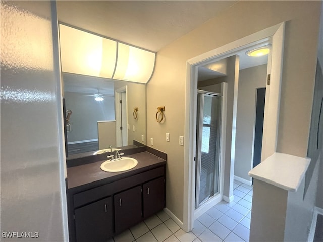 bathroom with vanity, ceiling fan, tile patterned flooring, and a shower with door