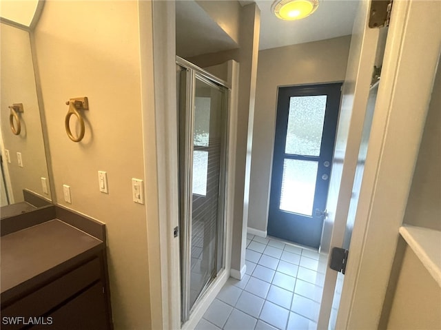 bathroom featuring vanity, tile patterned flooring, and a shower with door