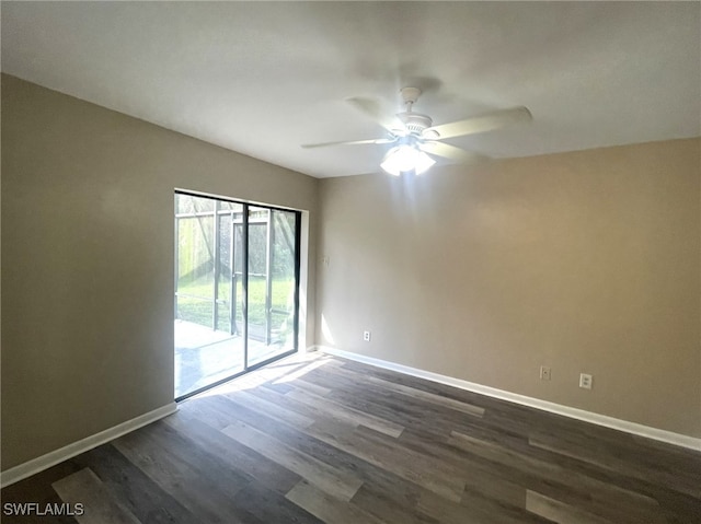 spare room with ceiling fan and dark hardwood / wood-style flooring