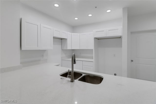 kitchen with white cabinetry and sink