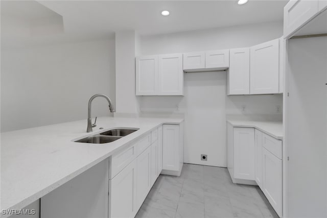 kitchen featuring sink and white cabinets