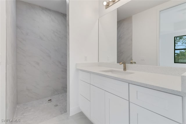 bathroom featuring vanity and a tile shower