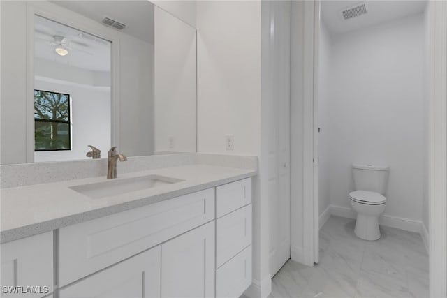 bathroom with ceiling fan, vanity, and toilet