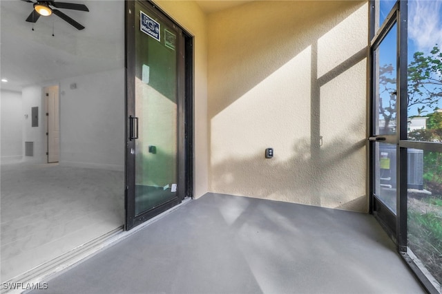 unfurnished sunroom featuring ceiling fan