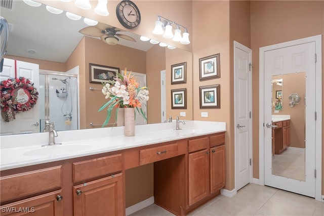 bathroom with ceiling fan, vanity, tile patterned flooring, and walk in shower