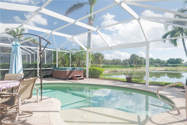 view of swimming pool with glass enclosure, a hot tub, a water view, and a patio