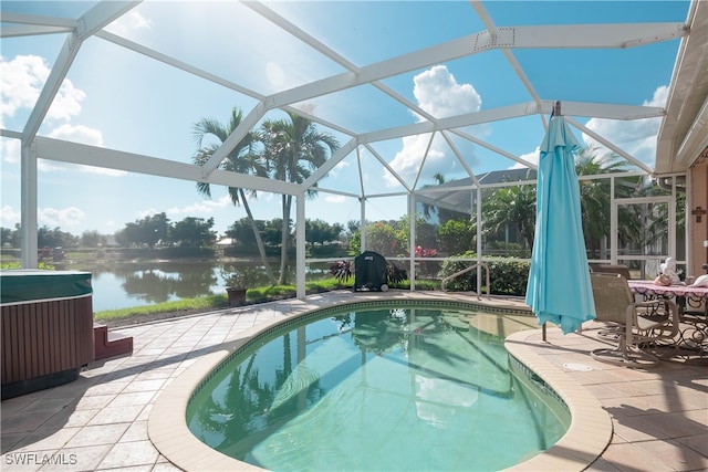 view of pool featuring a water view, a patio, and glass enclosure