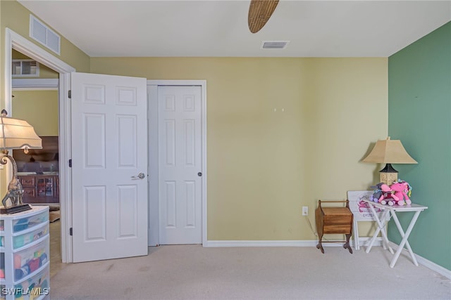 sitting room featuring ceiling fan and light colored carpet