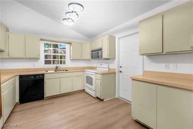 kitchen with black appliances, sink, vaulted ceiling, cream cabinetry, and light hardwood / wood-style flooring