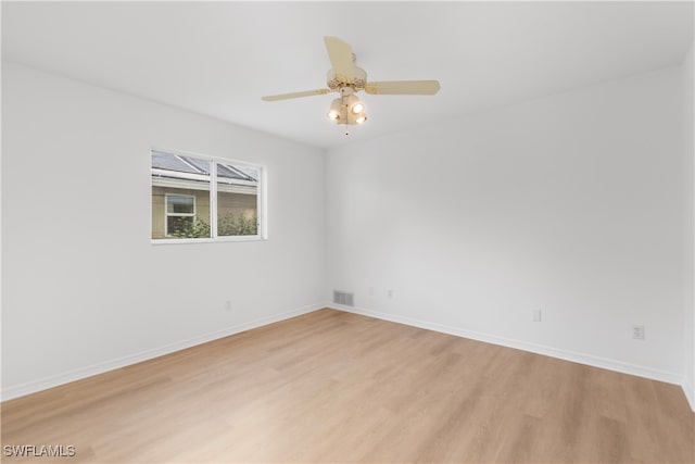 empty room with light hardwood / wood-style floors and ceiling fan