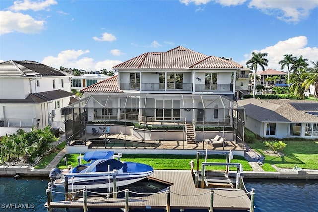 rear view of property with a water view and a balcony