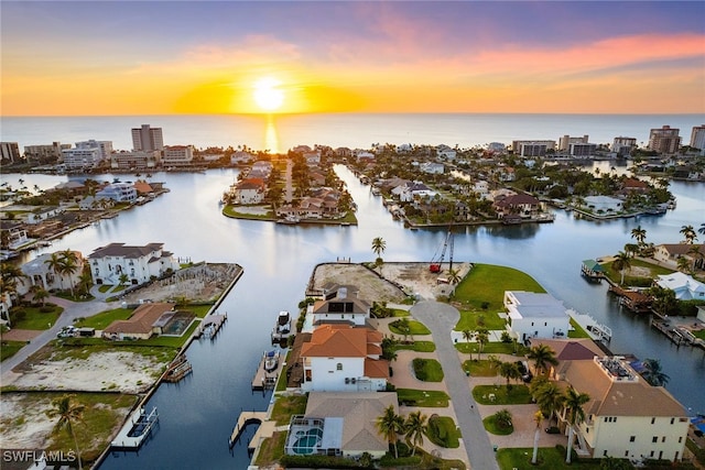 aerial view at dusk with a water view