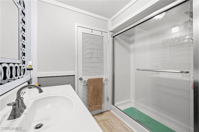 bathroom featuring sink and a shower with shower door