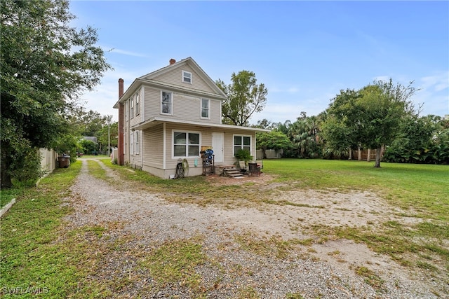 rear view of house with a yard