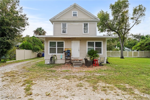 rear view of property featuring a yard