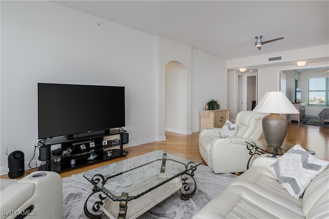 living room with hardwood / wood-style flooring and ceiling fan