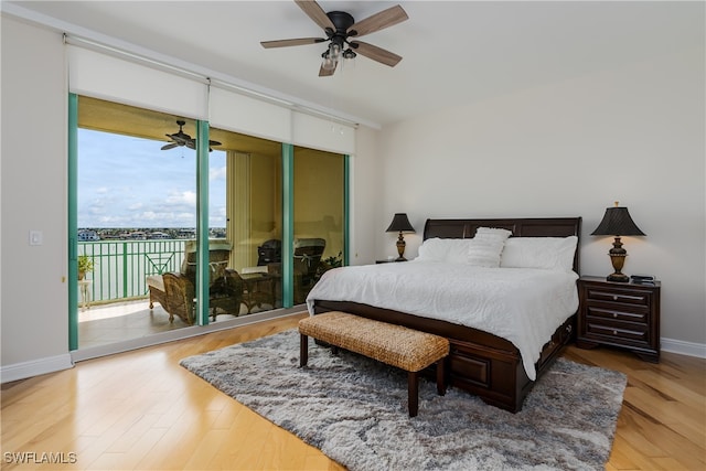 bedroom with multiple windows, wood-type flooring, ceiling fan, and access to exterior