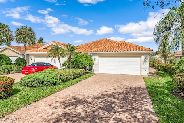 mediterranean / spanish-style home with a garage