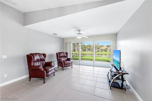 sitting room with light tile patterned flooring and ceiling fan