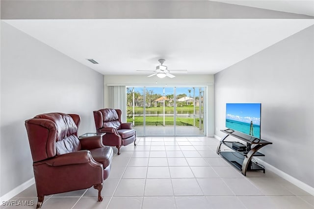 tiled living room with ceiling fan