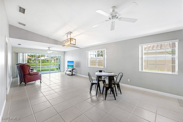 dining room featuring light tile patterned floors, ceiling fan, and vaulted ceiling