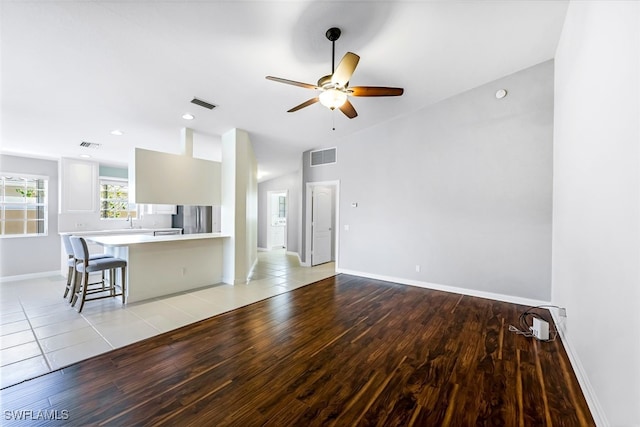 unfurnished living room featuring ceiling fan and light hardwood / wood-style floors