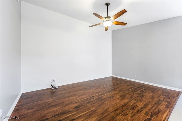 spare room featuring dark hardwood / wood-style floors and ceiling fan