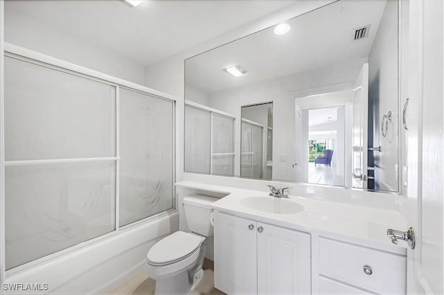 full bathroom with toilet, vanity, and shower / bath combination with glass door