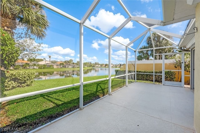 unfurnished sunroom featuring a water view