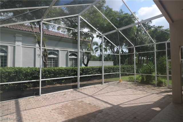 unfurnished sunroom with lofted ceiling