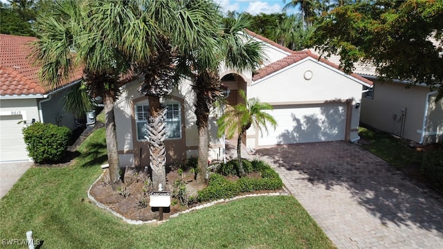 mediterranean / spanish-style house with a front lawn and a garage