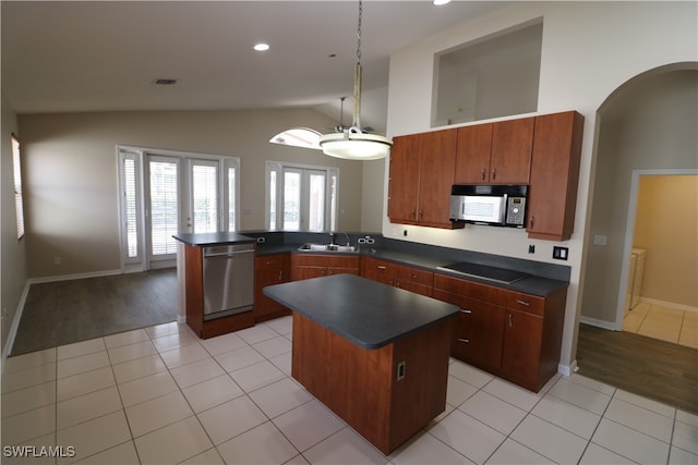 kitchen with black appliances, kitchen peninsula, lofted ceiling, a kitchen island, and french doors