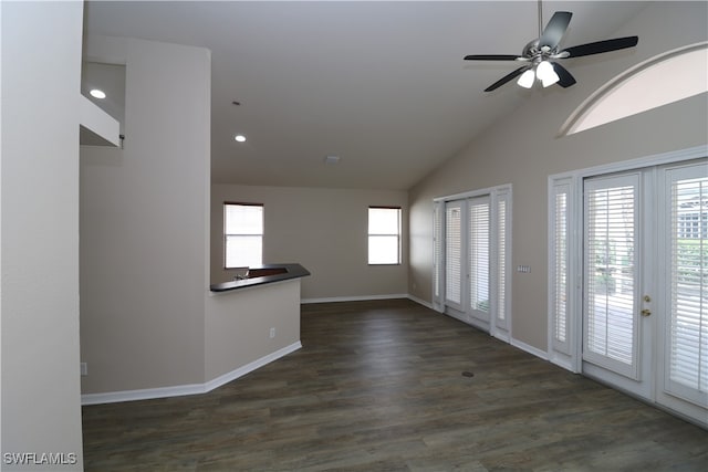 unfurnished room with ceiling fan, vaulted ceiling, dark hardwood / wood-style floors, and french doors