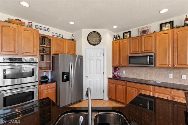 kitchen with decorative backsplash, sink, and appliances with stainless steel finishes