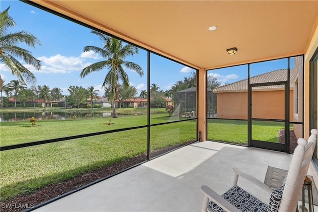 unfurnished sunroom featuring a water view and a healthy amount of sunlight