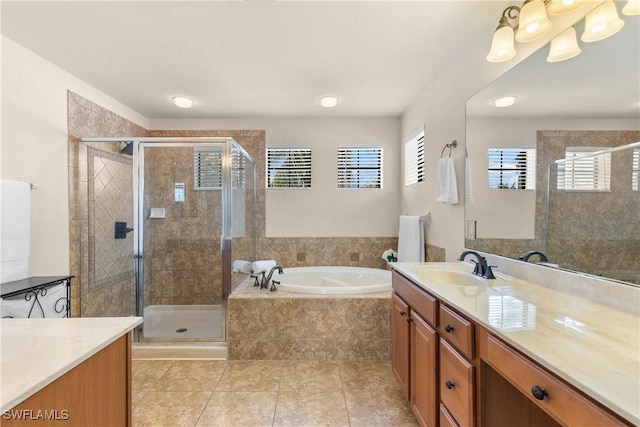 bathroom with tile patterned flooring, vanity, and plus walk in shower