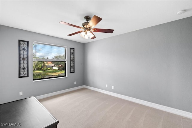 empty room featuring light carpet and ceiling fan