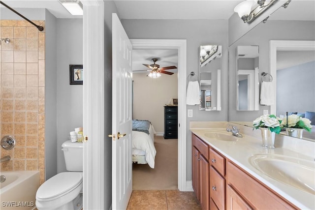 full bathroom with ceiling fan, tiled shower / bath combo, tile patterned flooring, toilet, and vanity