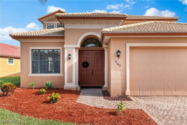 doorway to property with a garage