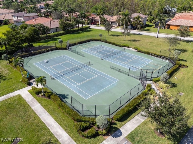 view of tennis court with a yard