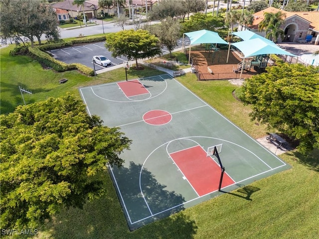 view of sport court with a lawn