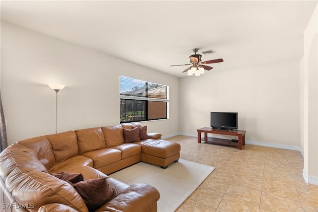 tiled living room with ceiling fan