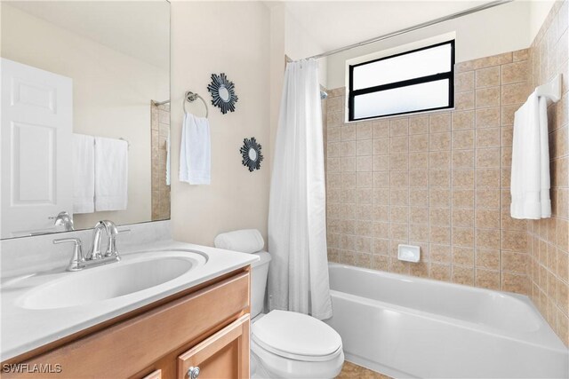 full bathroom with toilet, vanity, and shower / tub combo with curtain