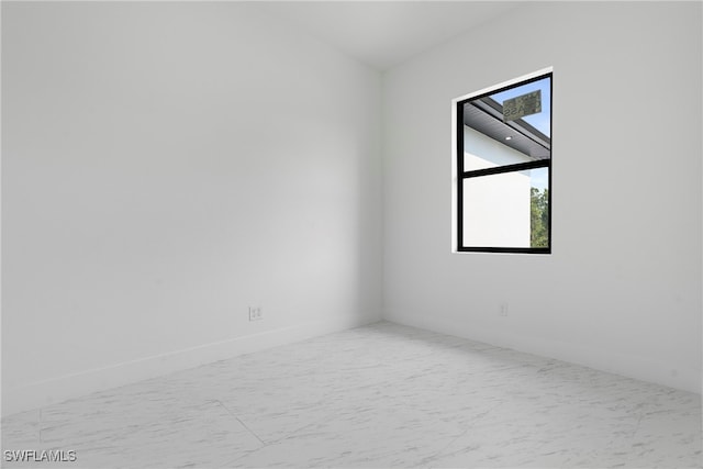 unfurnished room with a skylight