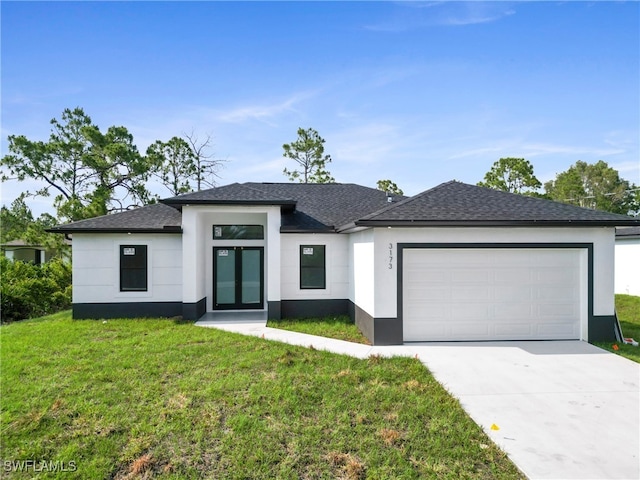 view of front of house with a garage and a front yard