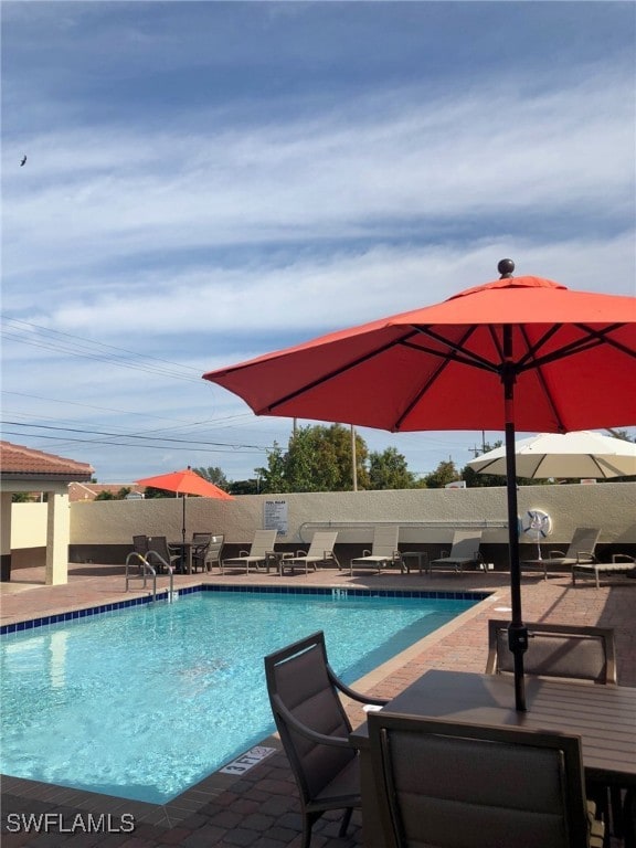 view of swimming pool featuring a patio area