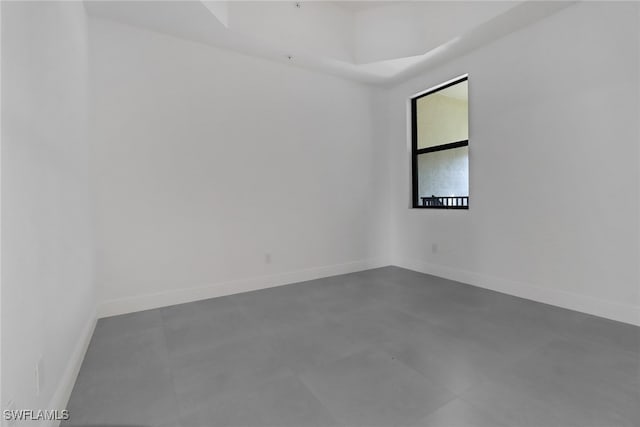 unfurnished room with concrete floors