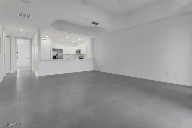 unfurnished living room with sink