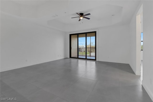 unfurnished room with a raised ceiling and ceiling fan