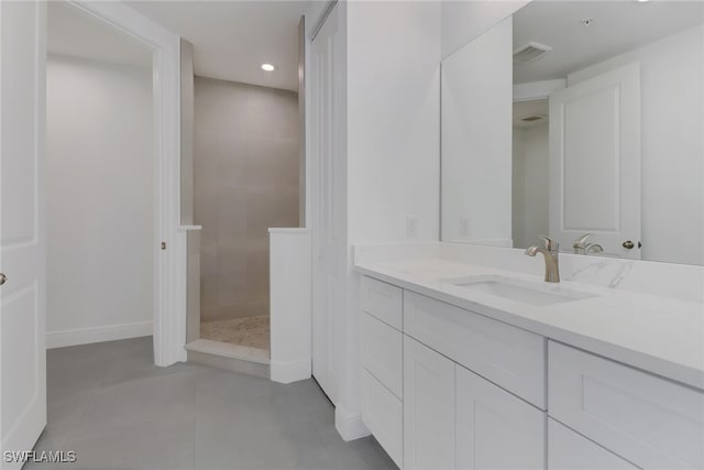 bathroom featuring vanity and tiled shower